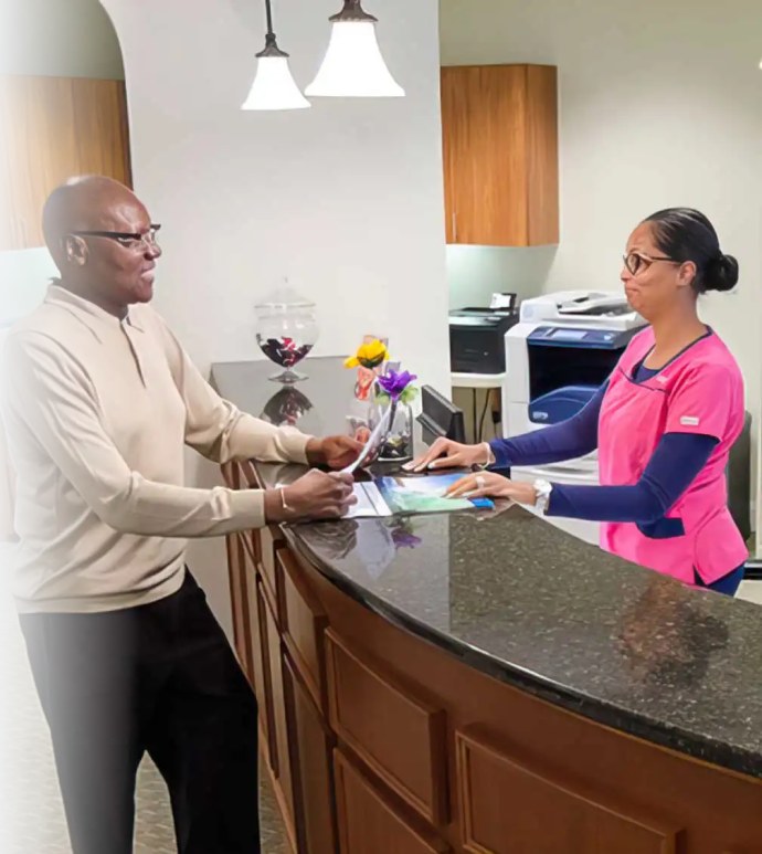 Front desk team welcoming a patient at Covington Family Dentistry