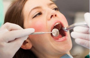Dentist examining a patient for restorative treatment